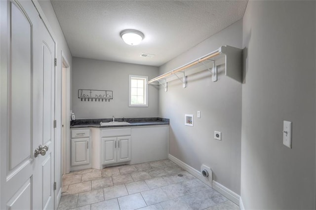 14095 NW 60th Ct, Parkville, MO 64152 - laundry room featuring electric dryer hookup, hookup for a washing machine, a textured ceiling, cabinet space, and light tile patterned flooring