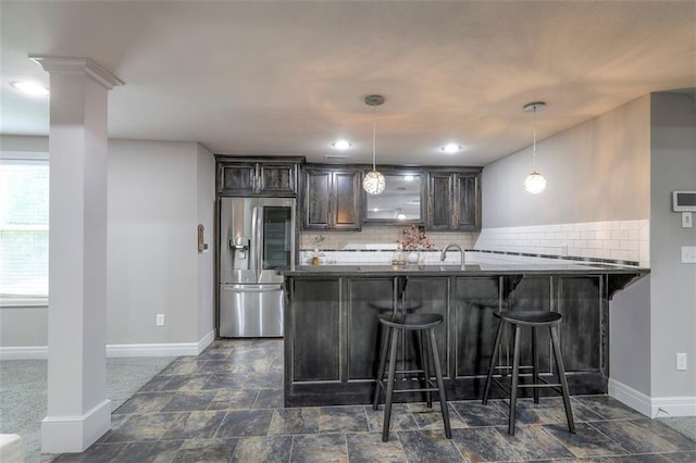 14095 NW 60th Ct, Parkville, MO 64152 - kitchen with stainless steel fridge with ice dispenser, a breakfast bar area, backsplash, and dark brown cabinetry