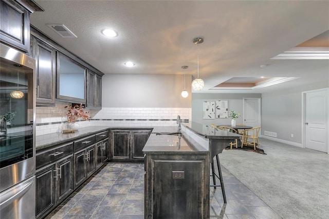 14095 NW 60th Ct, Parkville, MO 64152 - kitchen featuring a breakfast bar, backsplash, dark stone counters, a raised ceiling, and recessed lighting