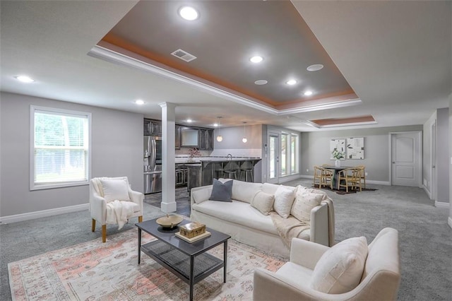 14095 NW 60th Ct, Parkville, MO 64152 - living room featuring a raised ceiling, light carpet, recessed lighting, ornate columns, and crown molding
