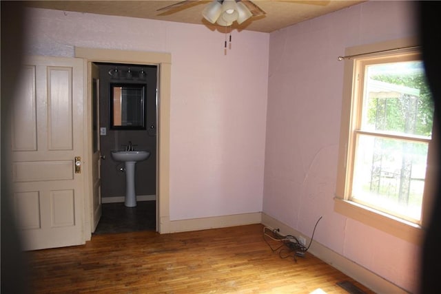 45 SW 675th Rd, Warrensburg, MO 64093 - spare room with healthy amount of natural light, wood finished floors, ceiling fan, and baseboards