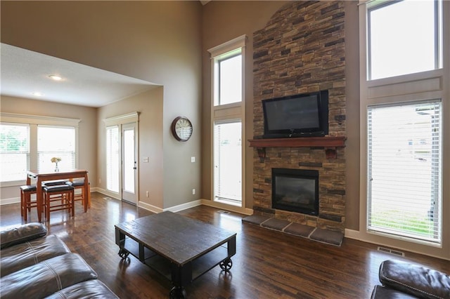 16488 S Summertree Ln, Olathe, KS 66062 - living room featuring wood finished floors, a fireplace, and a towering ceiling