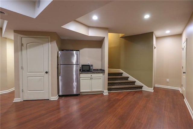 16488 S Summertree Ln, Olathe, KS 66062 - kitchen featuring freestanding refrigerator, black microwave, dark wood-style flooring, recessed lighting, and white cabinets