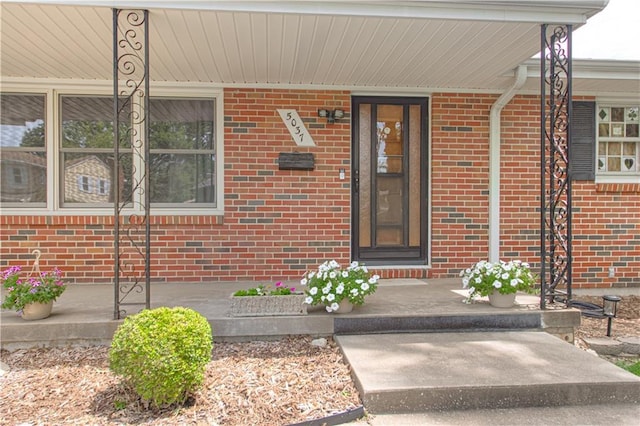 5037 Spring Ave, Kansas City, MO 64133 - property entrance featuring covered porch and brick siding