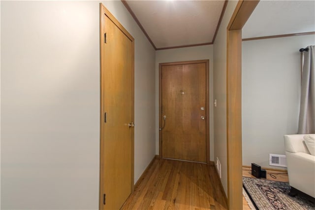 5037 Spring Ave, Kansas City, MO 64133 - hall with crown molding, light wood-style floors, and baseboards