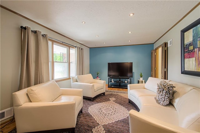 5037 Spring Ave, Kansas City, MO 64133 - living room featuring crown molding, recessed lighting, and a textured ceiling