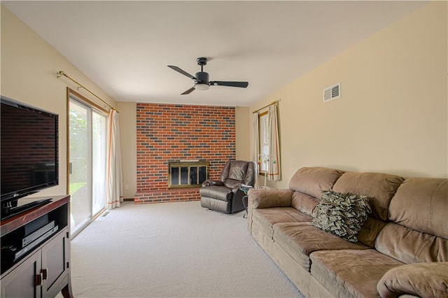 5037 Spring Ave, Kansas City, MO 64133 - carpeted living area with a ceiling fan and a fireplace