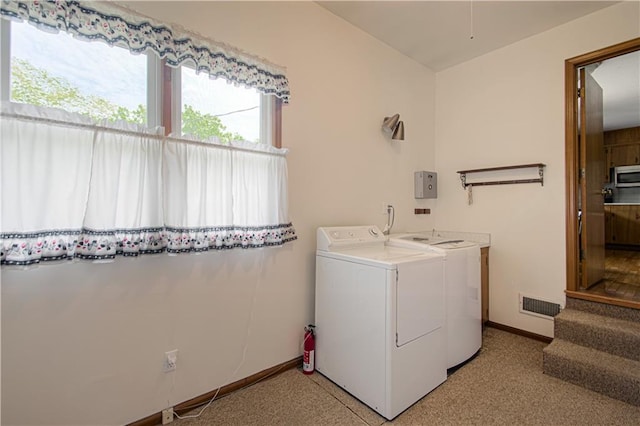 5037 Spring Ave, Kansas City, MO 64133 - laundry area featuring washing machine and clothes dryer and baseboards