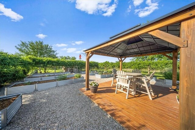 2640 Union Rd, Lawrence, KS 66044 - wooden deck with a vegetable garden, a gazebo, and outdoor dining area
