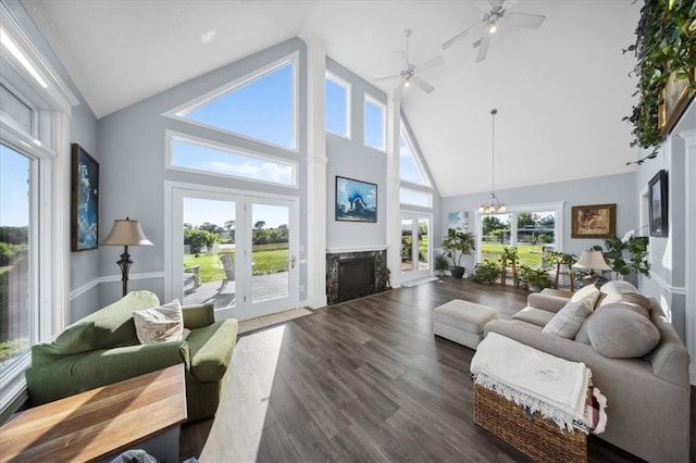 2640 Union Rd, Lawrence, KS 66044 - living room with a high end fireplace, high vaulted ceiling, dark wood finished floors, a ceiling fan, and a chandelier