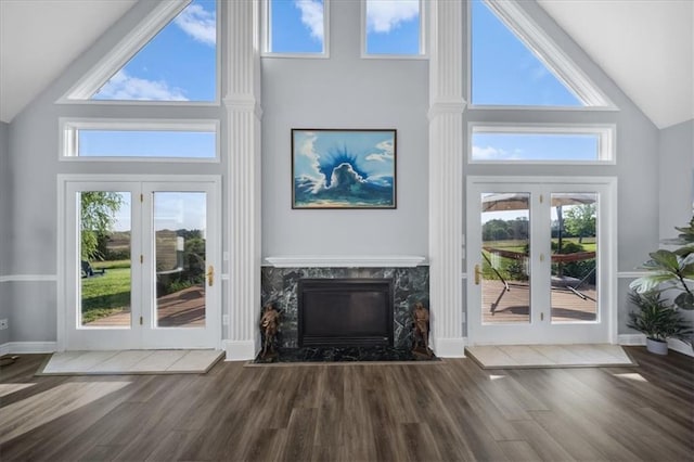 2640 Union Rd, Lawrence, KS 66044 - unfurnished living room featuring high vaulted ceiling, french doors, wood finished floors, and a high end fireplace