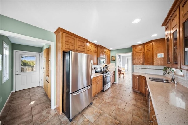 2640 Union Rd, Lawrence, KS 66044 - kitchen featuring stainless steel appliances, recessed lighting, tasteful backsplash, glass insert cabinets, and light stone countertops