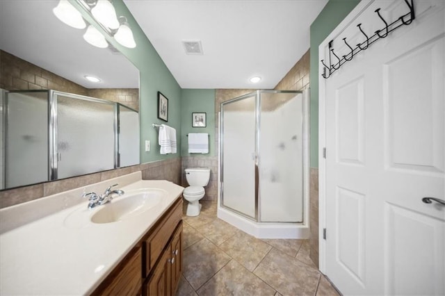 2640 Union Rd, Lawrence, KS 66044 - bathroom featuring vanity, a shower stall, tile walls, tile patterned floors, and a wainscoted wall