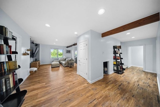 2640 Union Rd, Lawrence, KS 66044 - living room with wood finished floors, recessed lighting, a barn door, and beamed ceiling