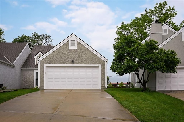 404 NE 96th Ter, Kansas City, MO 64155 - view of front of home featuring a front yard, stucco siding, and a garage