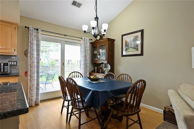 404 NE 96th Ter, Kansas City, MO 64155 - dining room with a chandelier, lofted ceiling, light wood-type flooring, and baseboards