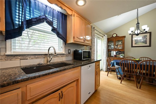 404 NE 96th Ter, Kansas City, MO 64155 - kitchen featuring white dishwasher, a sink, stainless steel microwave, tasteful backsplash, and vaulted ceiling
