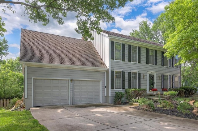 324 N Persimmon Dr, Olathe, KS 66061 - colonial house with driveway, an attached garage, and board and batten siding