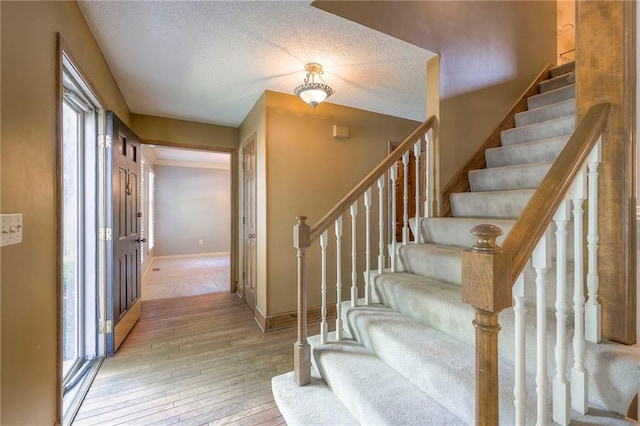 324 N Persimmon Dr, Olathe, KS 66061 - staircase with wood-type flooring and a textured ceiling
