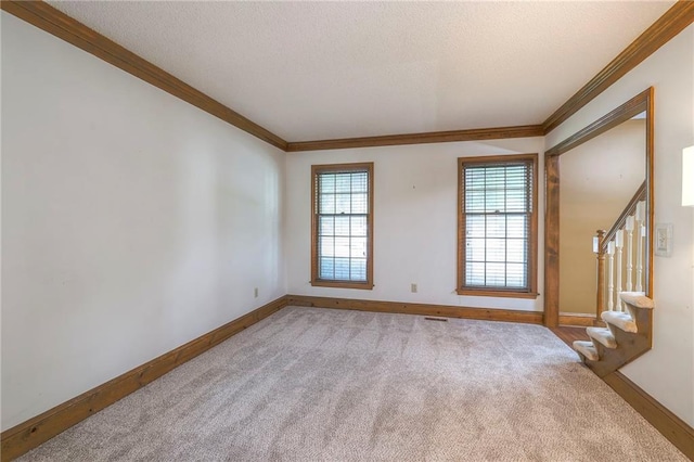 324 N Persimmon Dr, Olathe, KS 66061 - unfurnished room with carpet flooring, ornamental molding, stairway, and a textured ceiling
