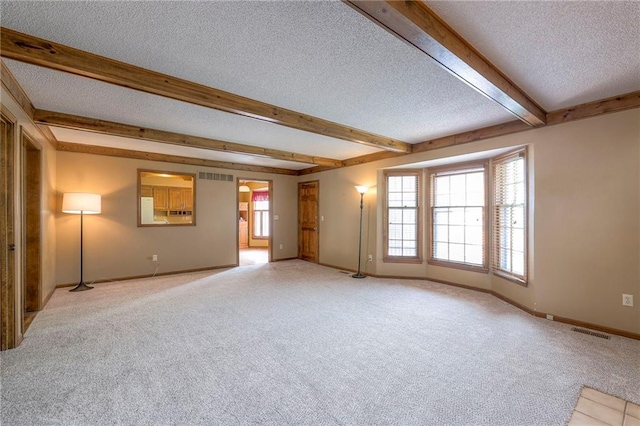 324 N Persimmon Dr, Olathe, KS 66061 - unfurnished room with a textured ceiling, light carpet, and beamed ceiling