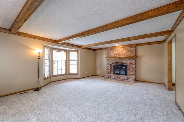 324 N Persimmon Dr, Olathe, KS 66061 - unfurnished living room with a textured ceiling, light carpet, beam ceiling, and a brick fireplace