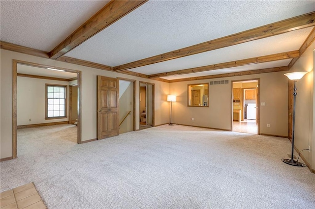 324 N Persimmon Dr, Olathe, KS 66061 - carpeted empty room featuring a textured ceiling and beamed ceiling
