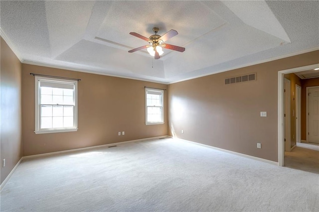 324 N Persimmon Dr, Olathe, KS 66061 - carpeted spare room featuring a raised ceiling, ceiling fan, plenty of natural light, ornamental molding, and a textured ceiling