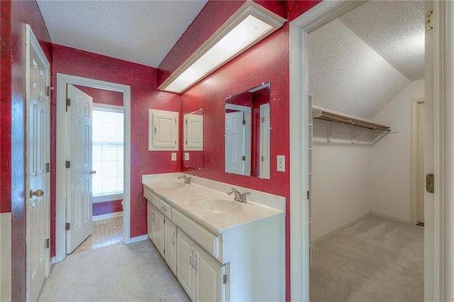 324 N Persimmon Dr, Olathe, KS 66061 - bathroom with a textured ceiling, double vanity, and lofted ceiling