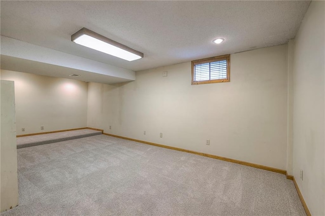 324 N Persimmon Dr, Olathe, KS 66061 - below grade area with light colored carpet and a textured ceiling