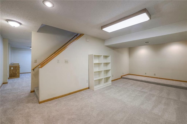 324 N Persimmon Dr, Olathe, KS 66061 - finished basement with carpet, a textured ceiling, and stairway