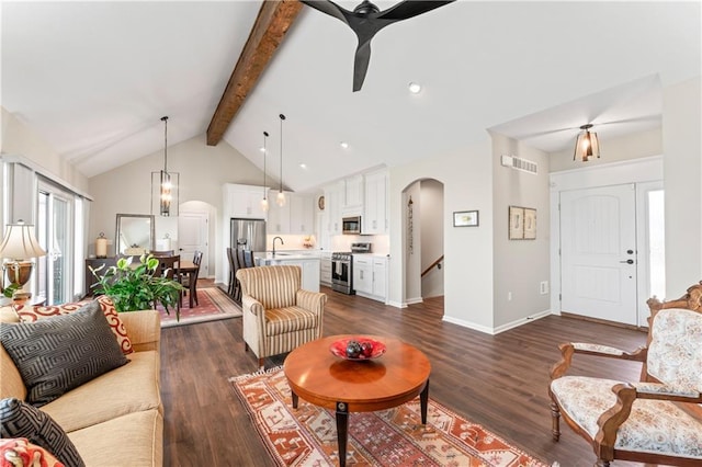 21115 W 186th Ter, Spring Hill, KS 66083 - living room with arched walkways, dark wood-style floors, baseboards, and ceiling fan