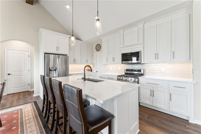 21115 W 186th Ter, Spring Hill, KS 66083 - kitchen featuring a sink, appliances with stainless steel finishes, a center island with sink, backsplash, and dark wood-style flooring