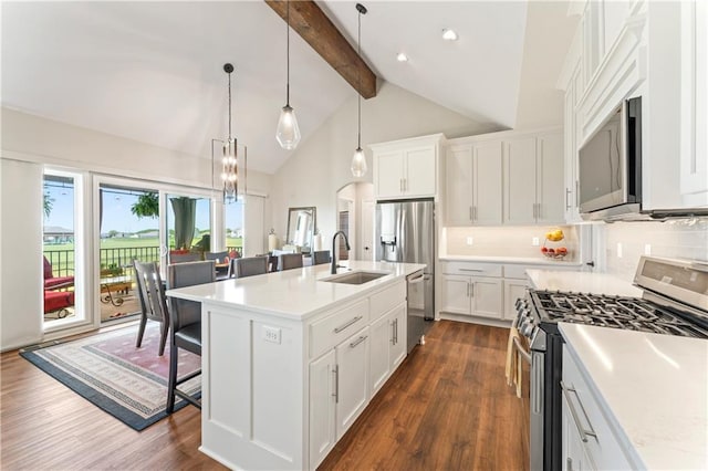 21115 W 186th Ter, Spring Hill, KS 66083 - kitchen with appliances with stainless steel finishes, a sink, dark wood finished floors, a breakfast bar, and beam ceiling