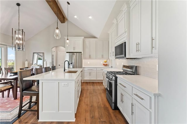 21115 W 186th Ter, Spring Hill, KS 66083 - kitchen with stainless steel appliances, a sink, beam ceiling, dark wood-style flooring, and white cabinetry