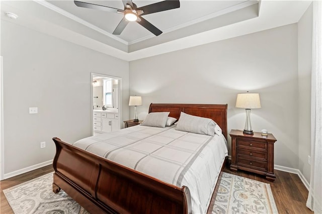 21115 W 186th Ter, Spring Hill, KS 66083 - bedroom featuring a tray ceiling, dark wood-style floors, baseboards, crown molding, and ensuite bath