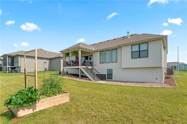 21115 W 186th Ter, Spring Hill, KS 66083 - back of house with central AC, a vegetable garden, a lawn, and stairway