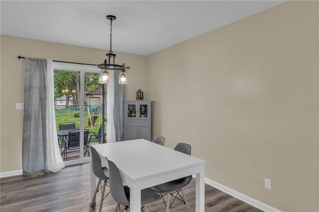 2604 S 16th Ter, Leavenworth, KS 66048 - dining area featuring a chandelier, baseboards, and wood finished floors