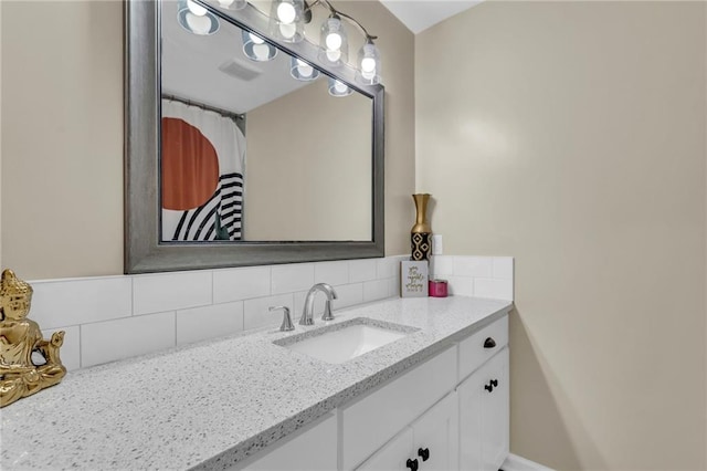 2604 S 16th Ter, Leavenworth, KS 66048 - bathroom featuring vanity and decorative backsplash