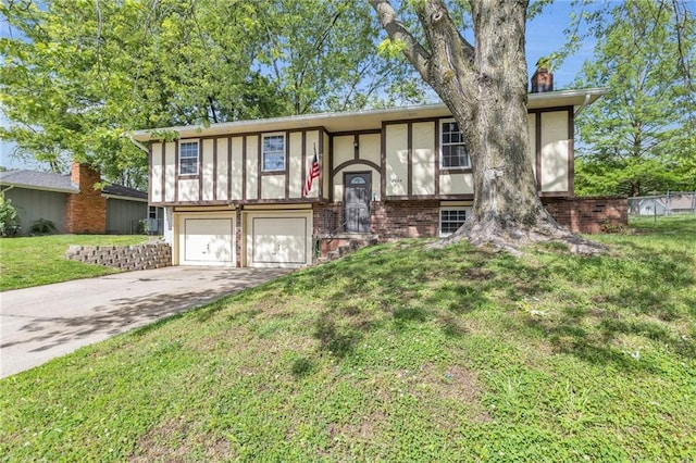 2604 S 16th Ter, Leavenworth, KS 66048 - raised ranch with an attached garage, driveway, a front lawn, a chimney, and brick siding