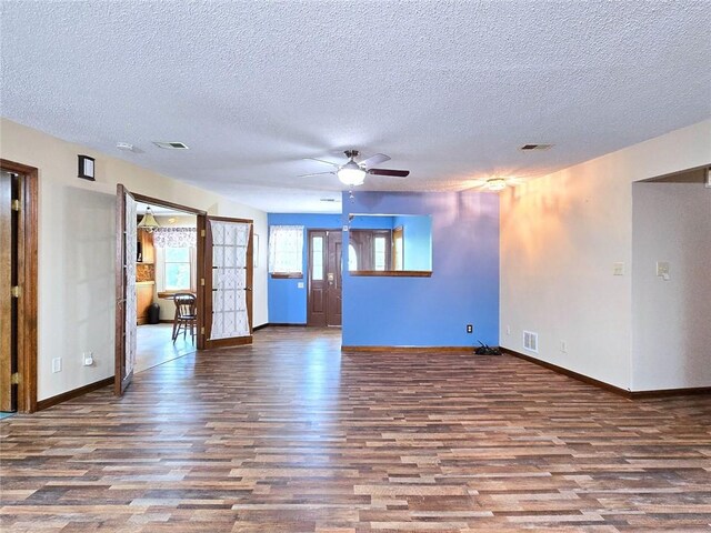 2101 Hillview Rd, Liberty, MO 64068 - unfurnished living room with wood finished floors, a textured ceiling, and ceiling fan
