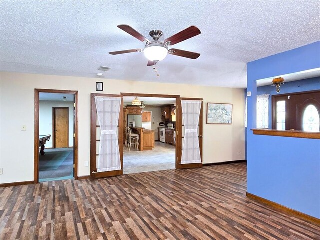 2101 Hillview Rd, Liberty, MO 64068 - unfurnished living room with wood finished floors, a textured ceiling, and ceiling fan