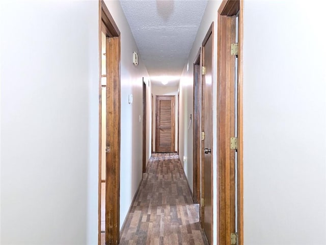 2101 Hillview Rd, Liberty, MO 64068 - hallway with a textured ceiling and wood finished floors