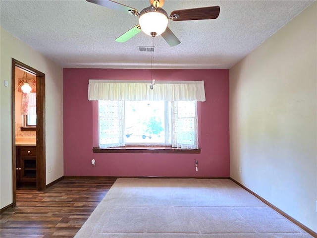 2101 Hillview Rd, Liberty, MO 64068 - spare room with a textured ceiling, a ceiling fan, and wood finished floors