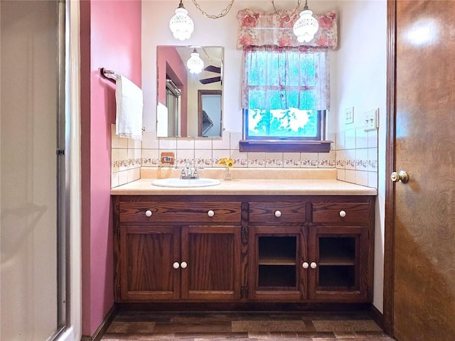 2101 Hillview Rd, Liberty, MO 64068 - full bathroom featuring vanity, decorative backsplash, and wood finished floors