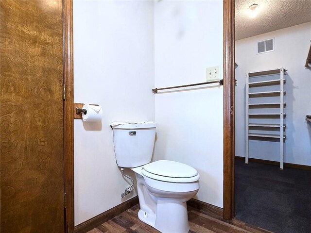 2101 Hillview Rd, Liberty, MO 64068 - bathroom featuring wood finished floors, a textured ceiling, and a closet