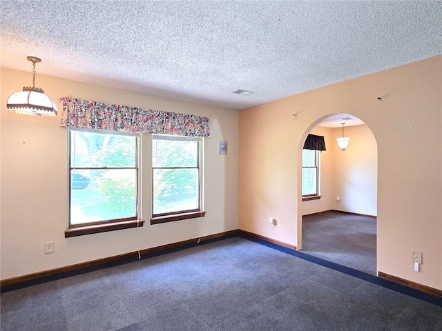 2101 Hillview Rd, Liberty, MO 64068 - carpeted spare room with a textured ceiling and arched walkways