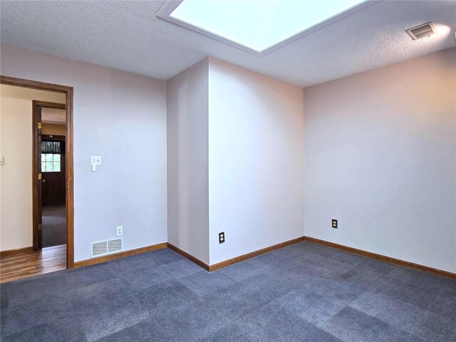 2101 Hillview Rd, Liberty, MO 64068 - spare room with dark colored carpet and a textured ceiling