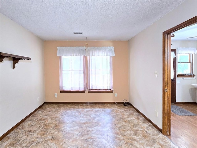 2101 Hillview Rd, Liberty, MO 64068 - spare room featuring a textured ceiling and baseboards