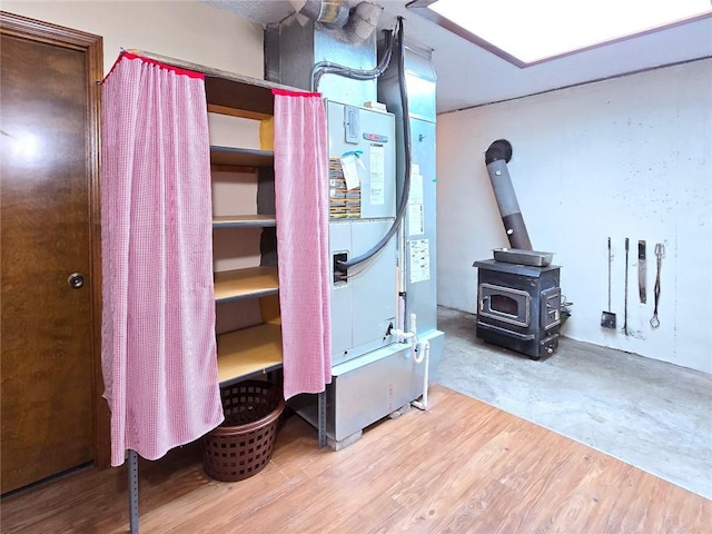 2101 Hillview Rd, Liberty, MO 64068 - bedroom featuring a wood stove and wood finished floors